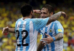 Argentina's Lucas Biglia (R) is embraced by teammate Ezequiel Lavezzi after he scored a goal against Colombia in their 2018 World Cup qualifying soccer match in Barranquilla, Colombia, November 17, 2015. REUTERS/John Vizcaino